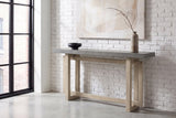 Urbania console table in Gray against a whitewashed brick wall in a loft entry, a branch in a stoneware vase