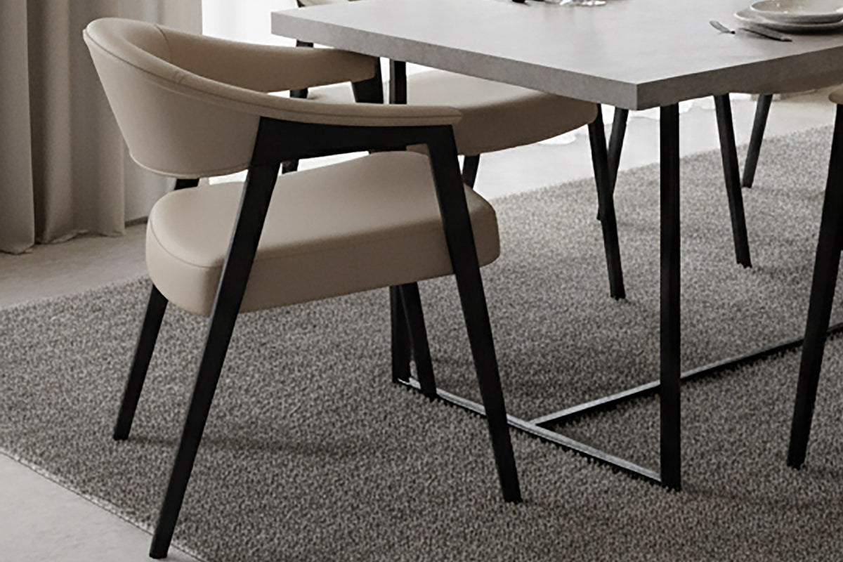Vance mushroom faux leather dining armchairs at a modern dining table on a grey rug
