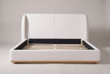 Varenna bed seen straight on from the foot: a two-panel headboard between two rounded wings
