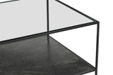 Vaughn coffee table corner showing the glass top, iron frame and textured lower shelf