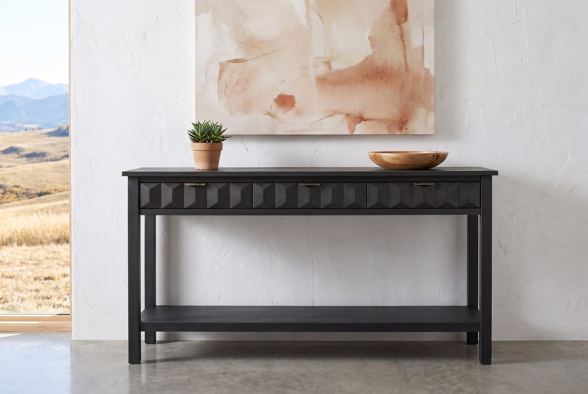 Black Velletri console table against a white plaster wall in a Calgary foothills house, a succulent and a wooden bowl on top