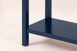 Close-up of a navy blue square leg and the lower shelf meeting it