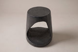 Venzone side table in Black, front view: a round ring-textured top and one rounded-triangle opening through the drum