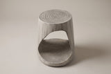 Venzone side table in Grey, front view: a round ring-textured top and one rounded-triangle opening through the drum