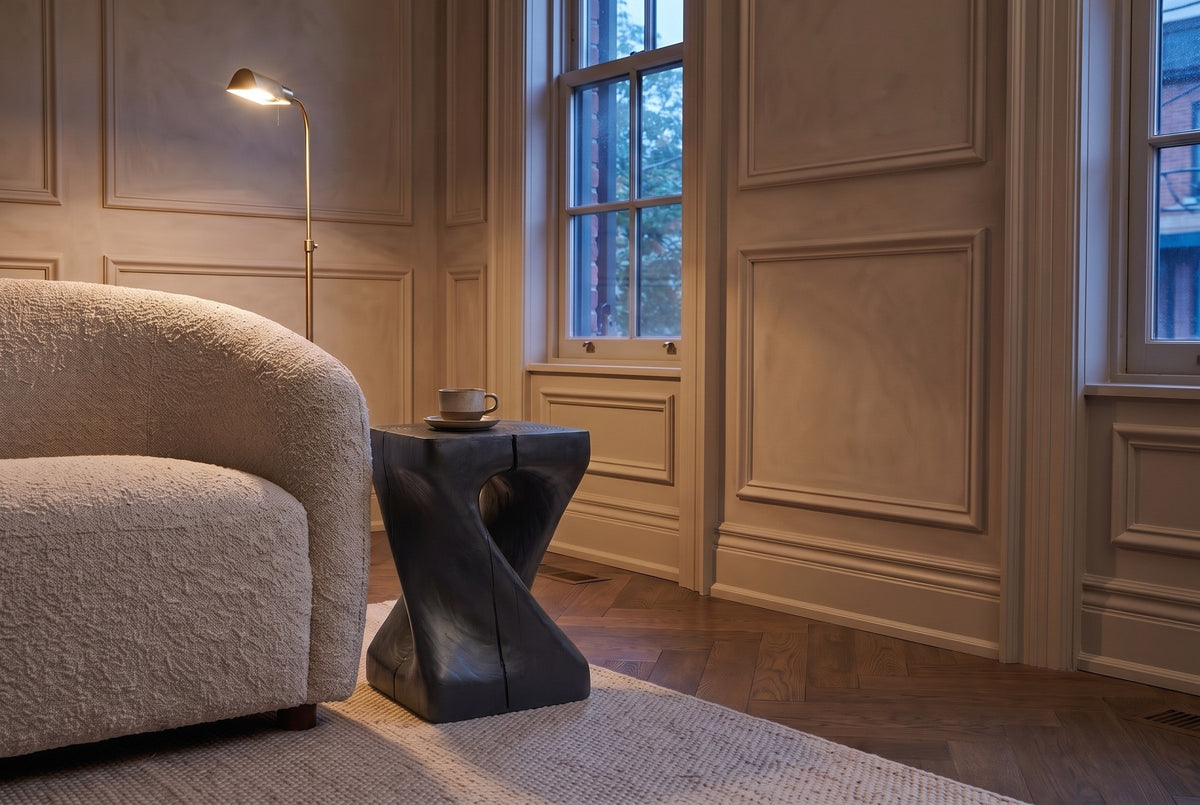 Vicenza side table in Black beside a boucle armchair in a panelled Toronto front room at dusk, a cup and saucer on top