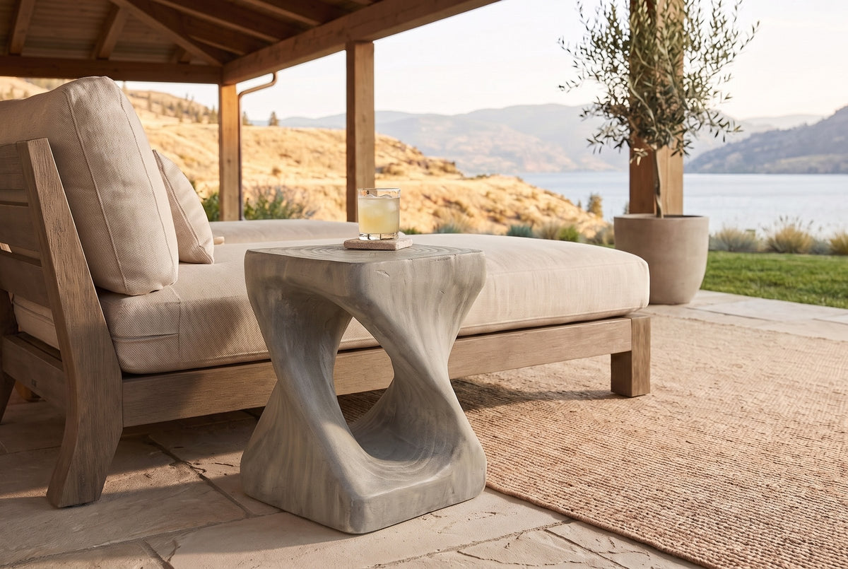 Vicenza side table in Grey beside an outdoor lounge on a covered Kelowna patio, the lake and dry hills beyond