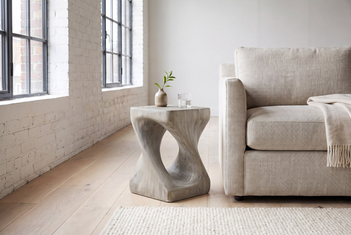 Vicenza side table in Grey beside an oatmeal linen sofa in a white-brick Montreal loft