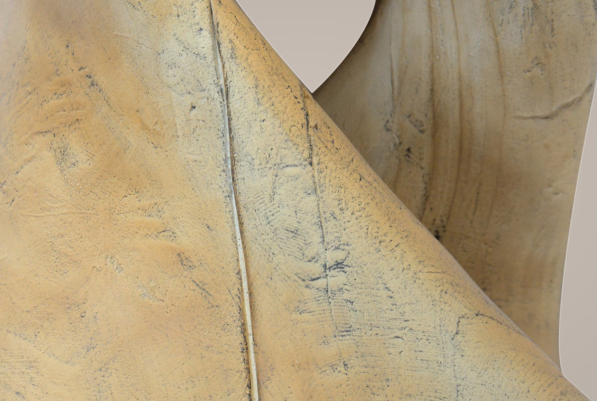 Close-up of the twist: carved facets, grain lines and a thin cast crack line running along the band