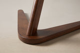 Close-up of the boomerang base: the rounded corner where the two arms meet, with the post set into it
