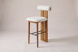 Vigoleno bar stool in Ivory, three-quarter view on a warm grey studio backdrop