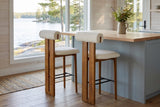 Two Vigoleno bar stools at a butcher-block island in a Muskoka cottage kitchen with a window onto the lake