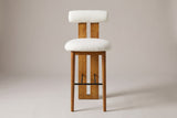 Vigoleno bar stool in White, straight front view: cylindrical bolster back on a slotted walnut-finish plank