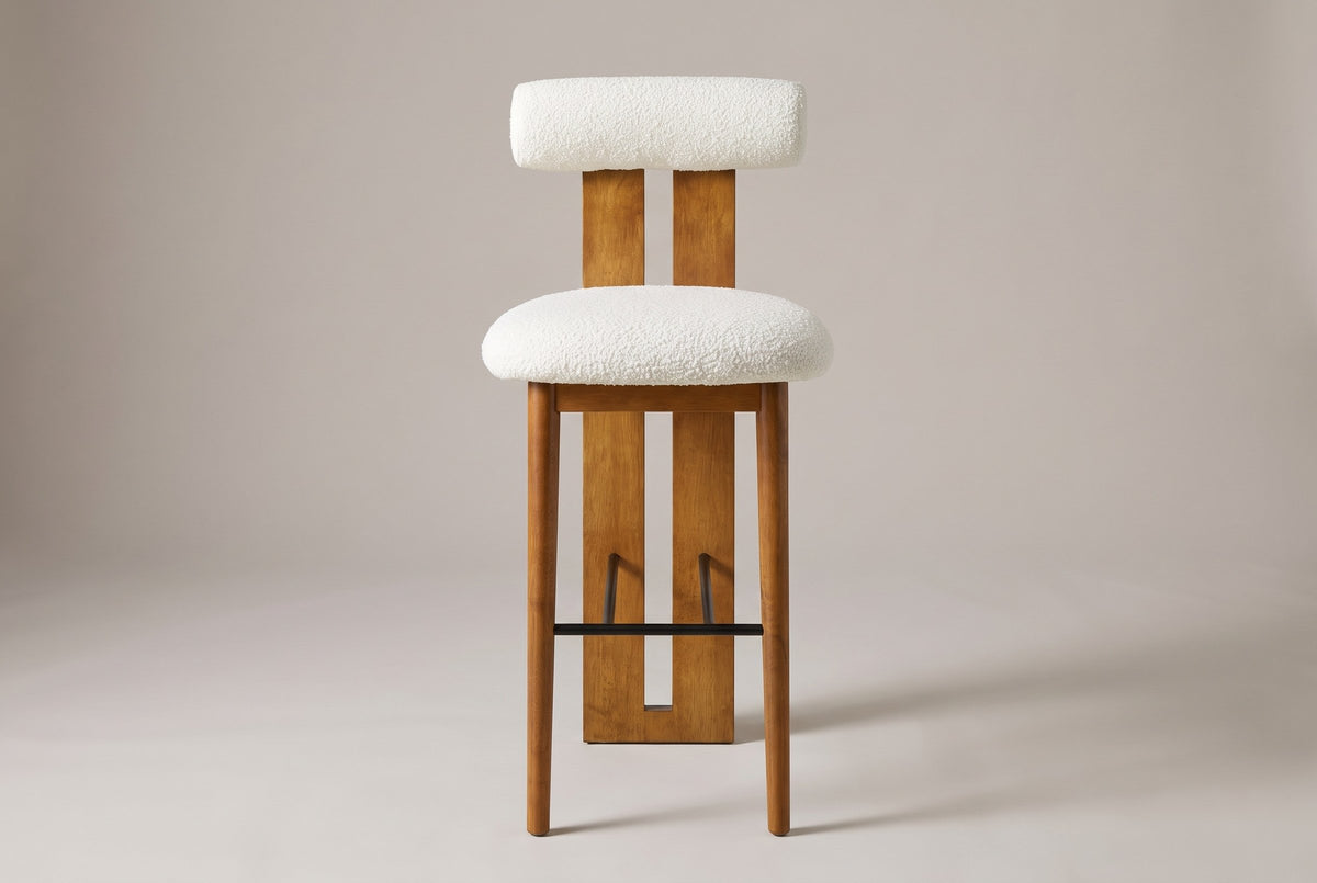 Vigoleno bar stool in White, straight front view: cylindrical bolster back on a slotted walnut-finish plank