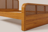 Close-up of the Vinci footboard corner: rounded top, square end post, woven band and plain wood panel