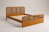 Vinci queen bed in a walnut stain with cane-style woven headboard and footboard panels