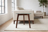 Vipiteno side table beside a cream linen sofa in a Montreal loft with whitewashed brick and factory windows