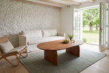 Visso coffee table in Pecan seen from above at the corner in a Bloomfield stone farmhouse