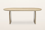 Visso dining table in Natural, straight front view on a warm white studio backdrop