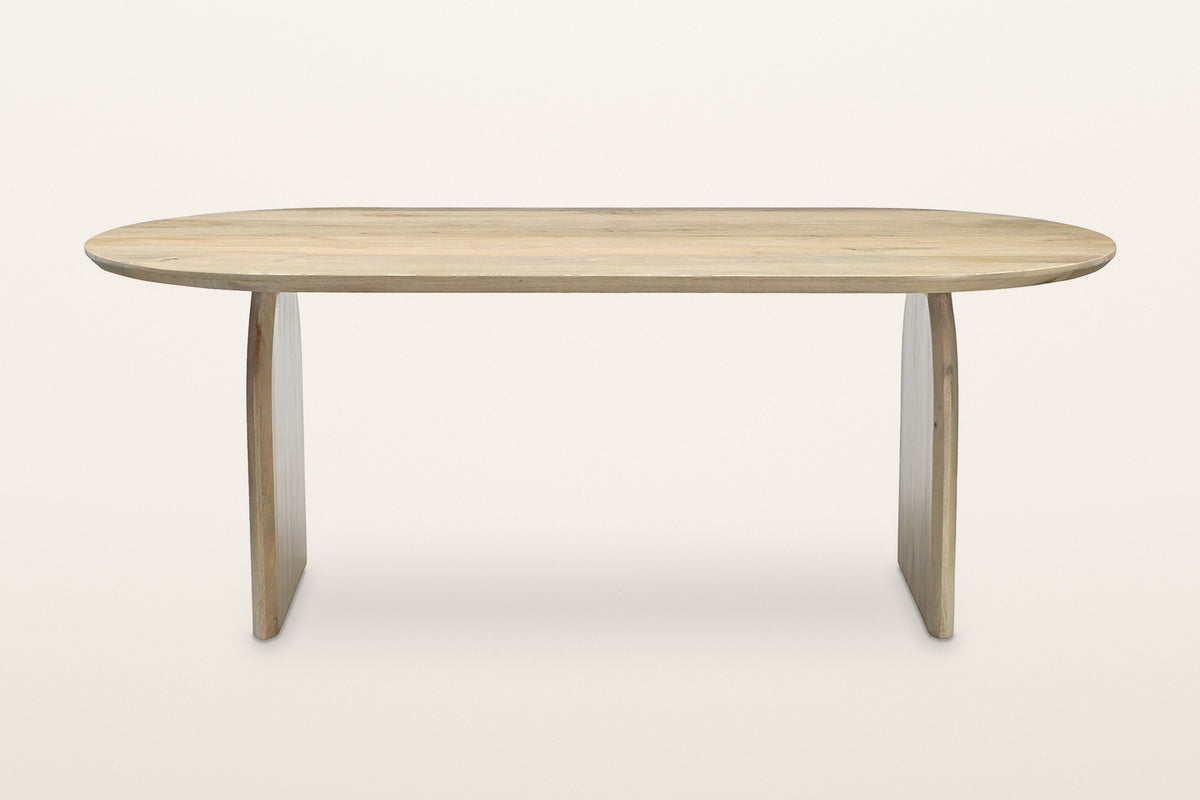 Visso dining table in Natural, straight front view on a warm white studio backdrop