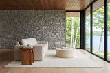End view of the Visso side table in Pecan at the arm of an oatmeal sofa in a Huntsville lake house