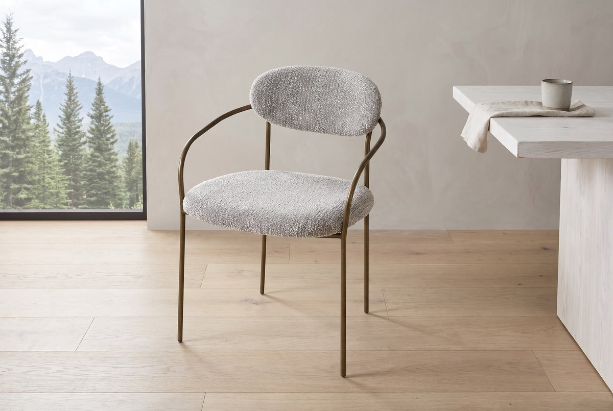 Vitorchiano arm dining chair in Pearl Grey bouclé against a plain plaster wall in a Canmore, Alberta dining room, spruce and mountains outside