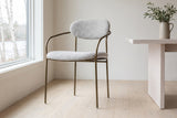 Vitorchiano arm dining chair in Pearl Grey bouclé by a tall window in a Wakefield, Quebec dining room, birches and the river outside
