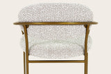The Vitorchiano counter stool from behind: the bronze hoop running behind the back pad and the two small plates that hold the pad to the rear legs