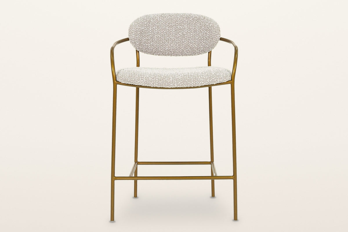 Vitorchiano counter stool from the front: the oval back pad between the two arms, the rounded seat, four straight legs and the footrest frame