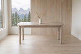 Vitorchiano dining table from the long side in a Canmore mountain house, the Three Sisters peaks through the window