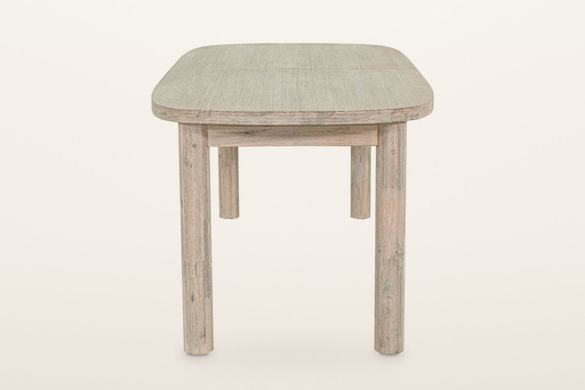 The short end of the Vitorchiano dining table: the rounded corners of the top, the apron and two round legs