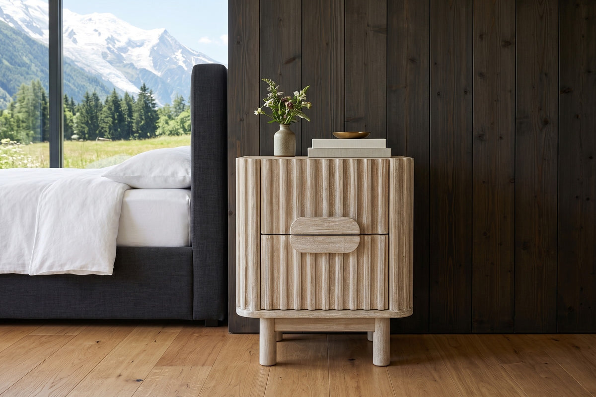 Vitorchiano nightstand in Natural White Wash, seen from the front beside a charcoal bed in a Chamonix chalet bedroom with smo