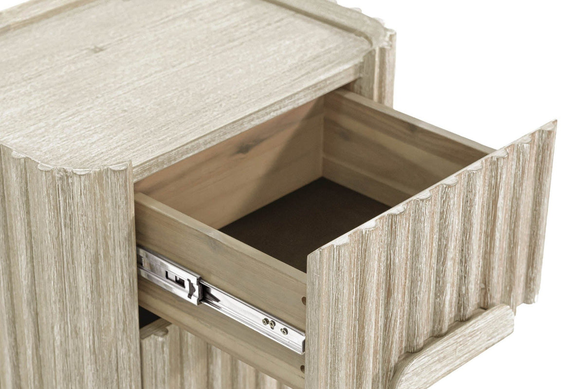 Close-up of the Vitorchiano top drawer pulled out: the acacia drawer box on a metal glide behind the reeded front