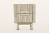 Vitorchiano nightstand in Natural White Wash, front view on a warm white studio backdrop: two reeded drawers and the split ov