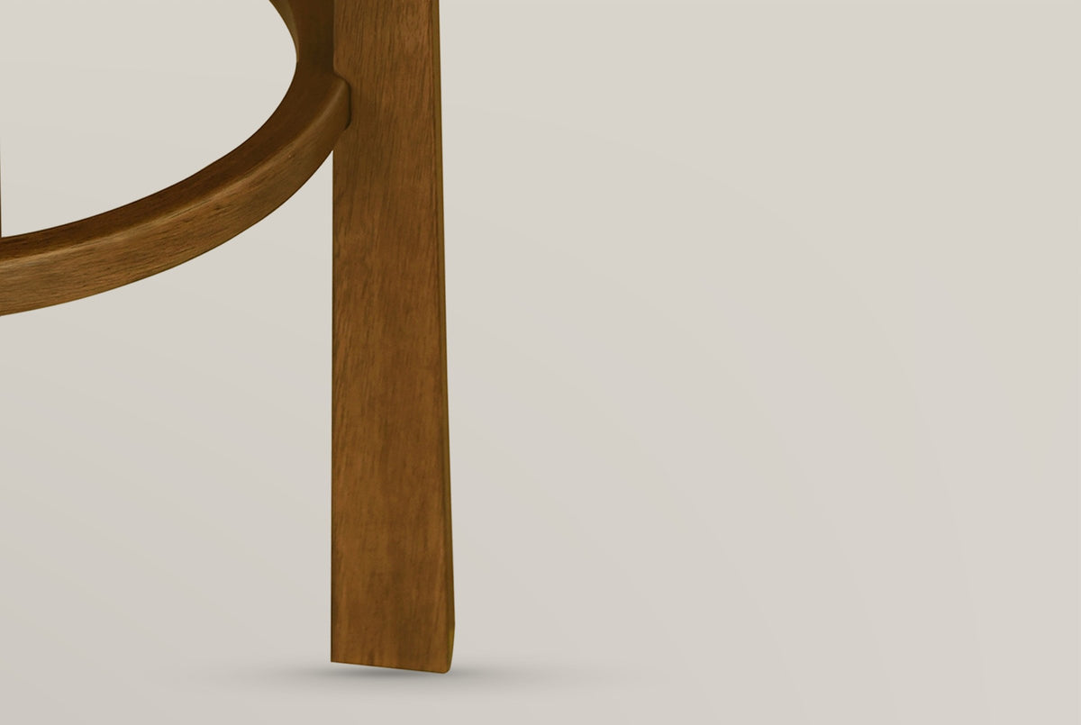 Close-up of the Vogogna round footring meeting a square Dark Walnut leg