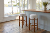 Two Vogogna bar stools at a butcher-block island in a Muskoka cottage kitchen with a window onto the lake