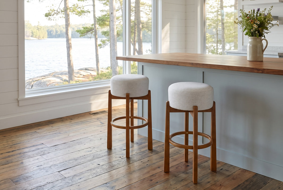Two Vogogna bar stools at a butcher-block island in a Muskoka cottage kitchen with a window onto the lake