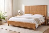 Volterra reeded bed in natural made up with white linen, in a bright bedroom with a fern