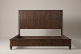 Volterra reeded bed in walnut, straight front view on a studio backdrop