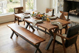 Wexford 70 in live edge dining table with bench by a stone fireplace