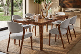 Winslow burl veneer dining table set for six with grey chairs in a sunlit garden room