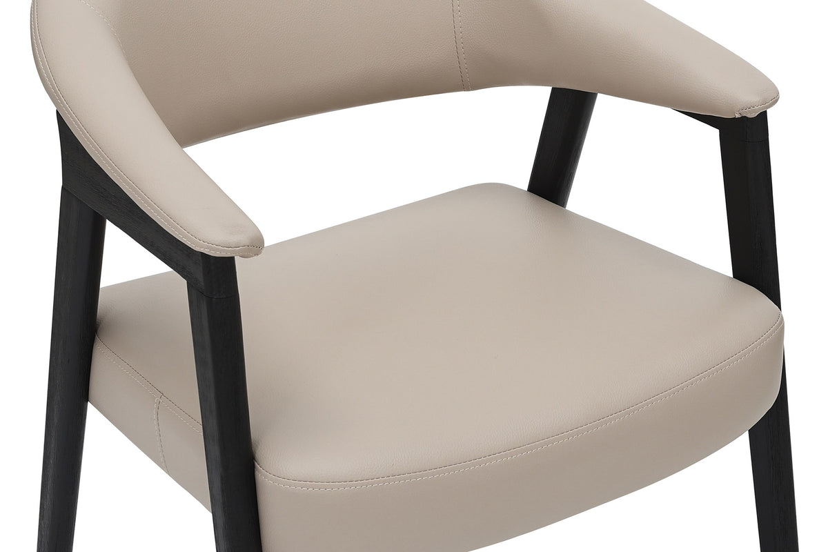 Close-up of the Yale armchair's curved mushroom faux leather back and seat