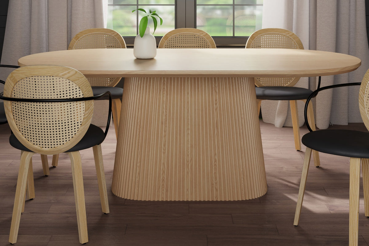 Yale natural oak veneer oval dining table with reeded pedestal in a bright dining room
