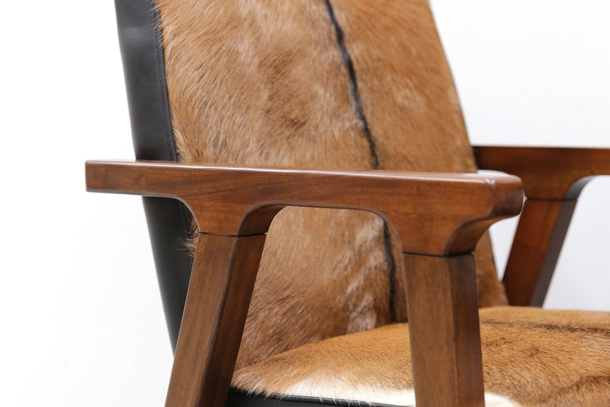 Yardley chair close-up of the goat hide back, black trim and oak arm