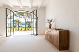 Zibello sideboard in Light Walnut seen from the end in a white plaster house on Porquerolles, with beams