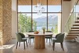 Zuccarello round dining table in an Invermere house, with a honey sandstone wall, a floating oak stair