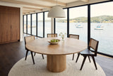 Zuccarello round dining table seen from above at the corner in a Lunenburg house, with walnut built-ins, a white dome pendant