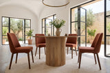 Zuccarello round dining table in a Noto villa, with white vaults, honey limestone