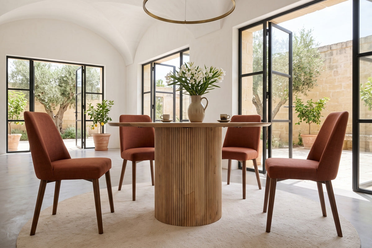 Zuccarello round dining table in a Noto villa, with white vaults, honey limestone