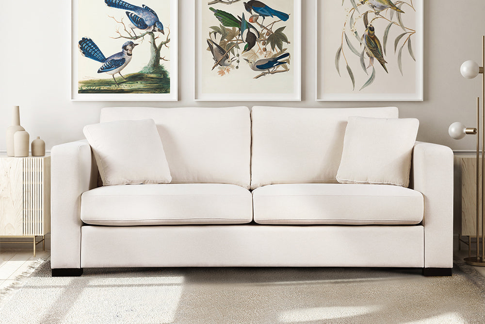 In a Living Room, There is Straight Front View of A Modern, Beige, Love-Seat, Harvard Modern Fabric Sofa with Two Side Cushions.